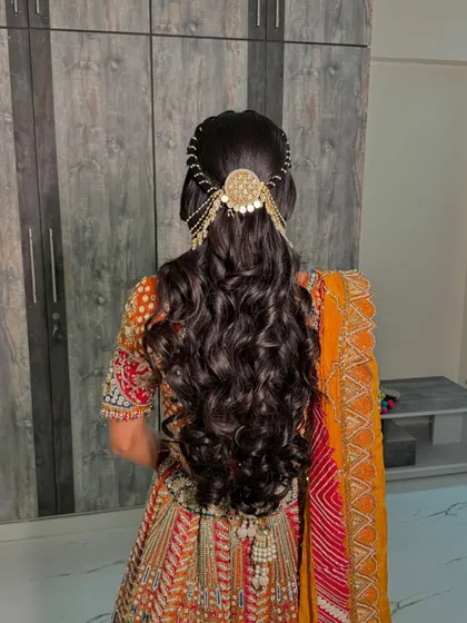 A closer look at the intricate hair accessory and the soft, bouncy curls created for this bride's engagement ceremony.