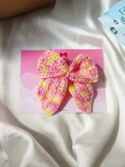 A multi-color pink and yellow sailor bow, perfect for a bright, summery hairstyle.