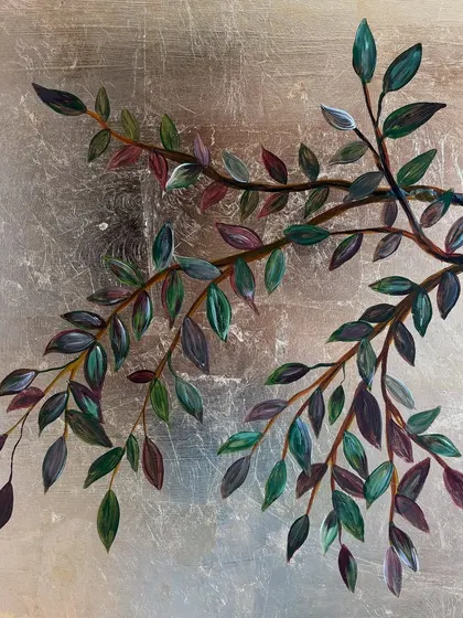 A close-up of painted branches on a silver leaf background. The cooler tone of the silver gives a different, more contemporary feel compared to the warmth of gold.