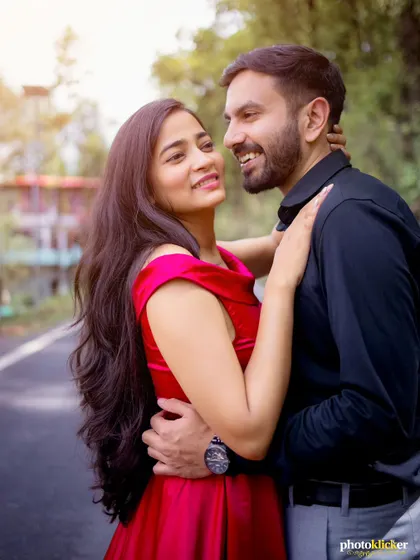 A close-up, natural light portrait of a couple sharing a happy and intimate moment during their outdoor pre-wedding shoot.