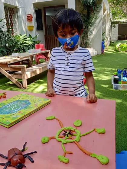 "A crazy alien beetle with 6 eyes!" When left to their own devices with playdough and loose parts, children's imaginations run wild. This creation, inspired by our bugs theme, even has a backstory connected to current events.