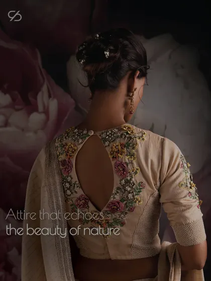 Wear the magic of floral motifs and the delicacy of nature. This blouse, with its keyhole back and intricate embroidery, echoes the beauty of the natural world.