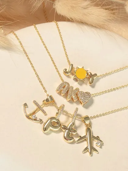 Personalize your necklace with words like 'JOY' or your initials. You can also create a story with charms like an anchor, a peace sign, or an airplane.