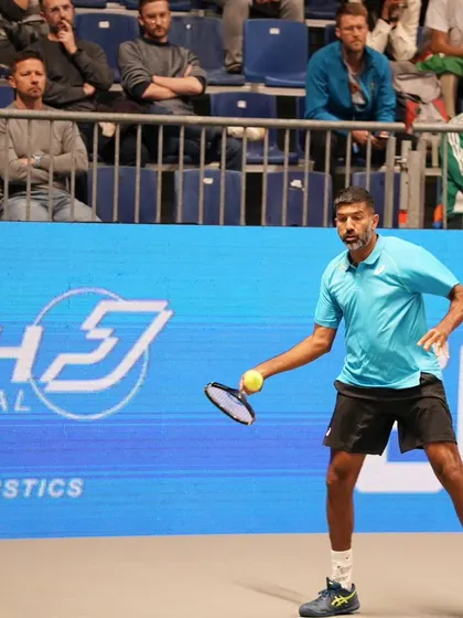Preparing for a backhand shot with a ready stance.