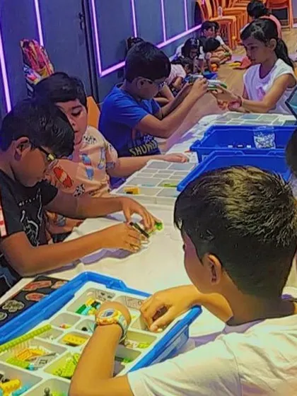 A focused classroom scene, with students using kits and tablets to bring their engineering ideas to life.