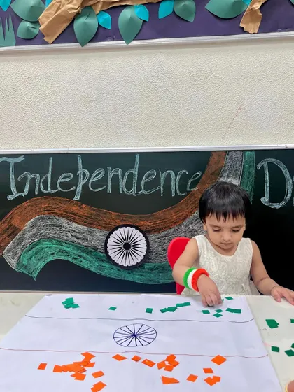 This young learner is focused on placing the green pieces on her flag collage. Celebrating national days through art helps instill a sense of patriotism from a young age.