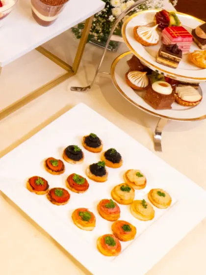 An array of exquisite French petit fours and canapés. This collaboration allowed me to blend my style with classic Parisian pastries for a truly unique offering.