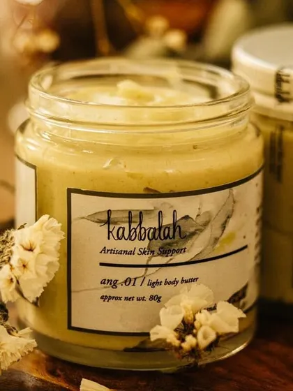 The 'Ang' light body butter, with its soft green hue from natural oils. It's designed for sensitive and dry skin, providing rich moisture with a light feel.