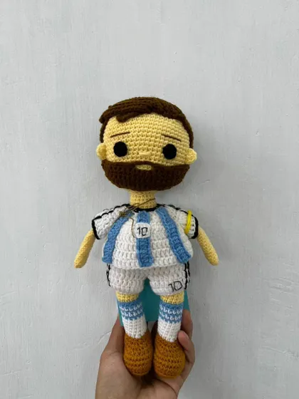 A clear, front-facing shot of the handmade Messi doll, capturing the details of his number 10 jersey.