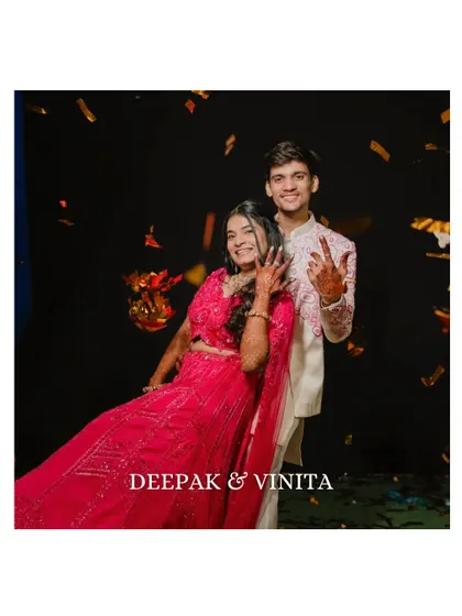 A fun and celebratory shot of the couple amidst falling confetti. Their joyful expressions and the dynamic composition perfectly capture the spirit of the Sangeet.
