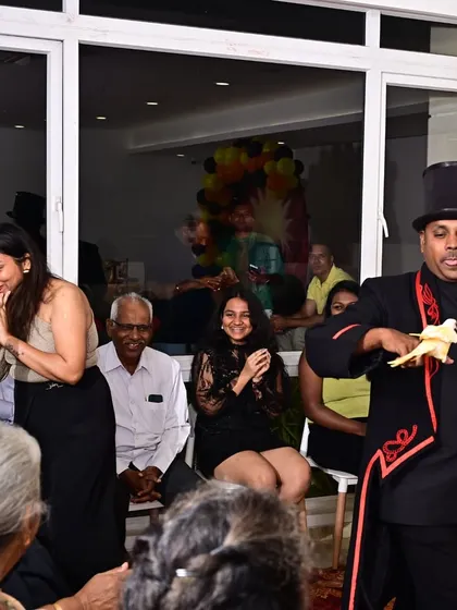 The look of pure astonishment is what I live for. Here, I am performing the classic dove production, a timeless piece of magic that delights audiences of all ages at corporate family days and celebrations.