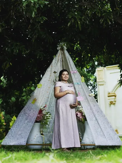 This light pink polka dot gown is perfect for a whimsical, boho-themed maternity shoot, especially with a cute teepee prop like this one.