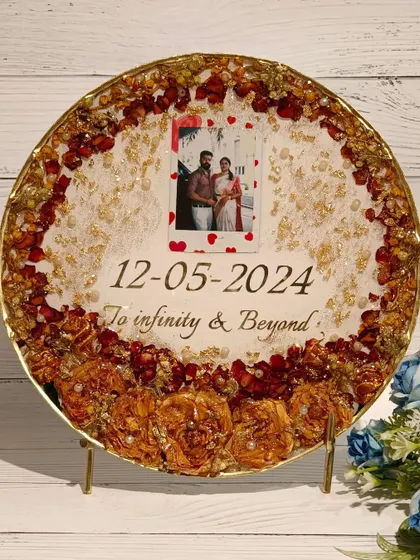 A duplicate of image 116, this round plaque features a polaroid-style photo and the phrase "To infinity & Beyond" with a border of preserved flowers.