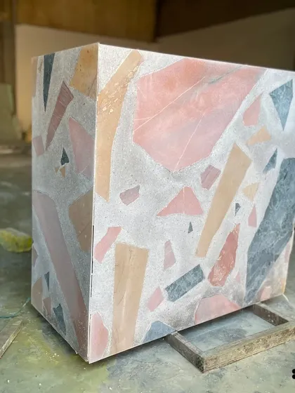 A solid block of our custom Venetian terrazzo, ready to be cut and polished. This shows the material in its raw, three-dimensional form before it becomes a finished product.