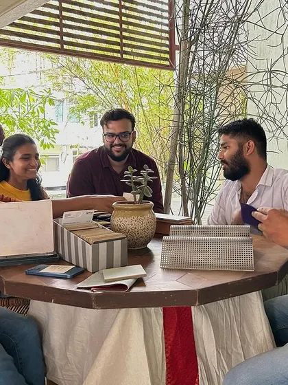 A small group discussion around a table of samples.