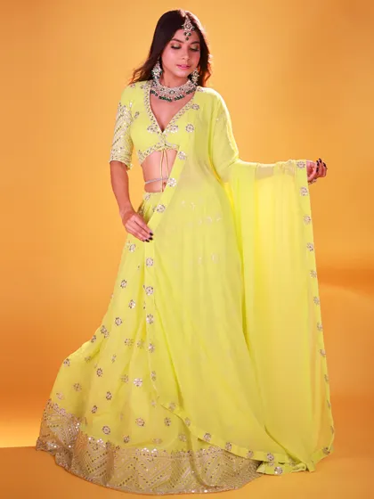 A studio shot focusing on the flow and drape of the neon green lehenga. The model's pose allows the fabric to move, and the lighting captures the movement beautifully.