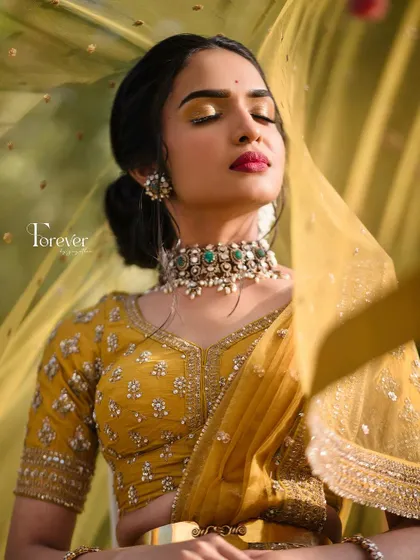 A close-up of a bride's pre-wedding look, with a focus on the golden eyeshadow and the beautiful choker necklace.