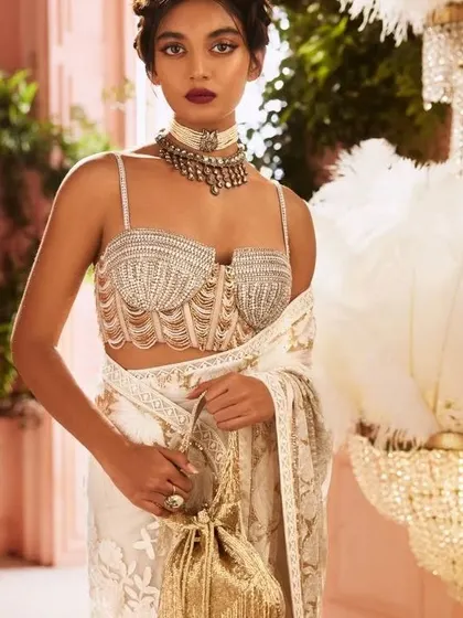 The embellished bustier blouse is a huge trend. I can create a custom, perfectly-fitted blouse like this to be paired with a saree or lehenga for a glamorous look.