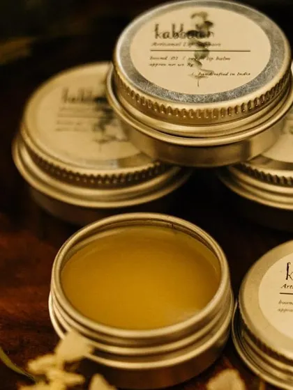 An open tin of 'Boond' vegan lip balm, surrounded by others. This product is a testament to the power of simple, plant-derived ingredients.