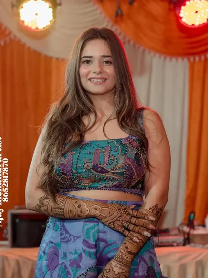 A happy client with her beautiful, traditional mehndi, ready for the wedding festivities.