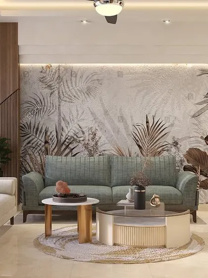 This living room design uses a nature-inspired wallpaper as a feature wall. The gentle curves of the sofas and the mix of neutral and soft green tones create a space that feels calm and refreshing.