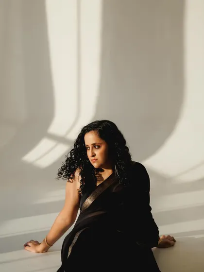 An artistic shot using shadows. The minimal makeup ensures that the focus is on the mood and composition of the photograph.