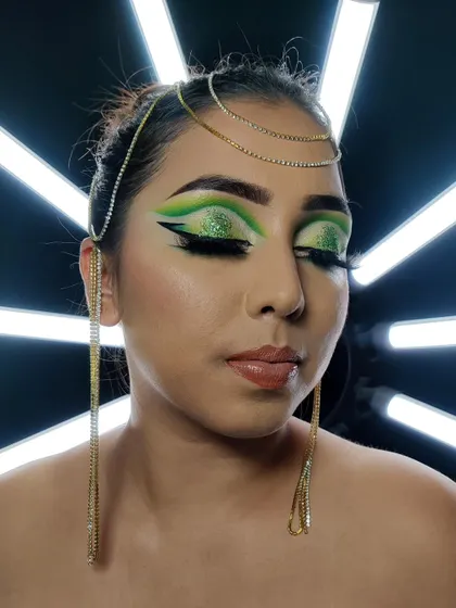 A close-up of the Arabic eye makeup, showing the glitter detail on the lid and the sharp, clean lines of the winged liner.