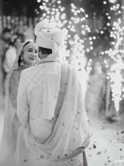 The Varmala ceremony captured in timeless black and white, with sparklers creating a magical, celebratory atmosphere.