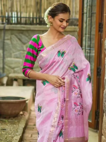 A vibrant checkered blouse in pink and green, paired with a lovely pink embroidered linen saree. This look is fresh, colorful, and perfect for spring.