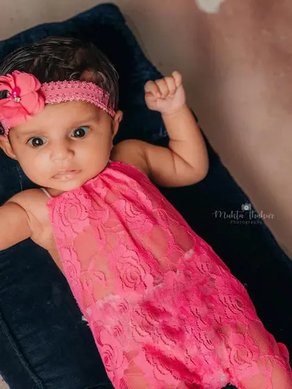 This little beach baby is ready for some sun. The pink lace outfit and matching headband add a pop of color to this fun, summery newborn shoot.
