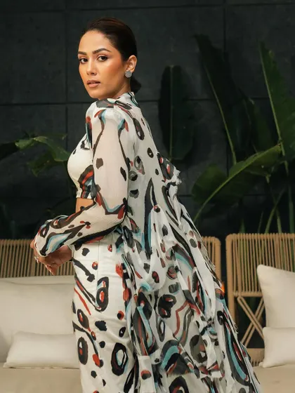 An over-the-shoulder shot that captures the movement of the flowing cape and adds a dynamic element to the portrait.