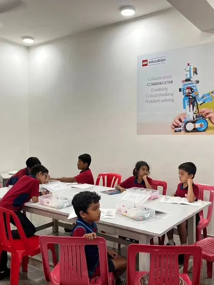 A wide view of our classroom at Vidyashilp Academy, where students are spread out and engaged in their individual and group LEGO projects.