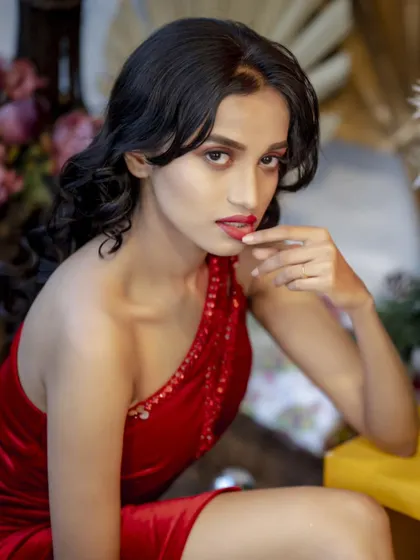 This close-up shot focuses on the subject's expression and the vibrant red of the dress. It’s a bold and beautiful portrait that captures the festive spirit.