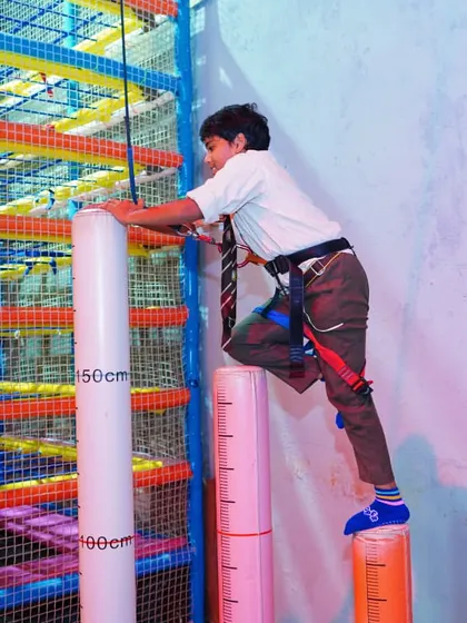 The pillar climbing challenge is a test of balance and courage. It's one of the many adventure activities students love.