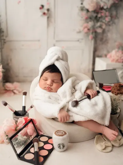 This little lady is taking a break from her busy schedule of being cute. The mini Starbucks cup and laptop add a hilarious touch to this spa-themed shoot.