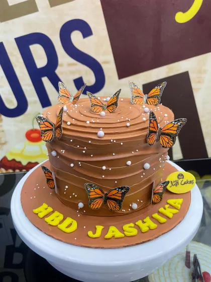 A 1.5kg chocolate cake decorated with elegant monarch butterfly toppers.