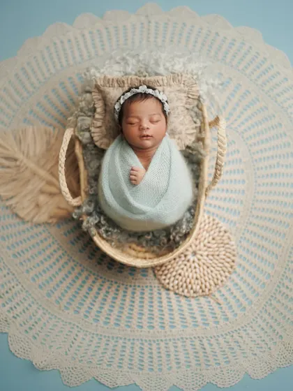 Another angle of this dreamy cloud setup. The intricate lace blanket and woven props add beautiful texture to this peaceful portrait.