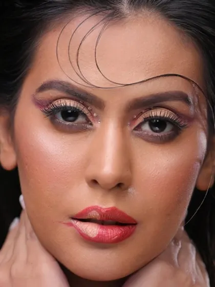A close-up on the face, showing the details of the eye and lip makeup.