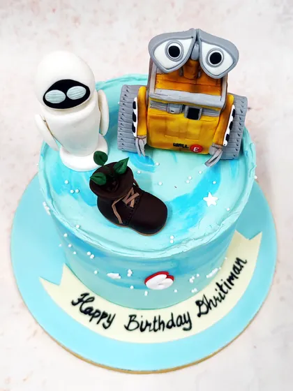 We celebrate a futuristic friendship with this heartwarming Wall-E and Eve cake. The detailed, handcrafted figures of the beloved robots are placed on a celestial blue cake, complete with the iconic boot plant, capturing the magic of the classic Pixar film.