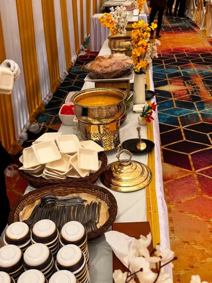 This buffet setup for the C.S.I.F unit at Andheri Airport features a vibrant and colorful theme. The patterned carpet is complemented by our elegant white and gold decor and floral arrangements.