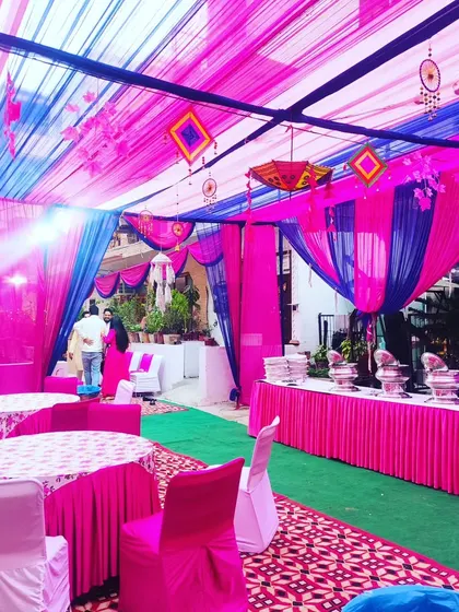 Inside a festive tent, I ensure the entire space is decorated. This view shows the coordinated seating arrangements, catering tables, and ceiling drapes that create a complete and immersive experience for your guests.