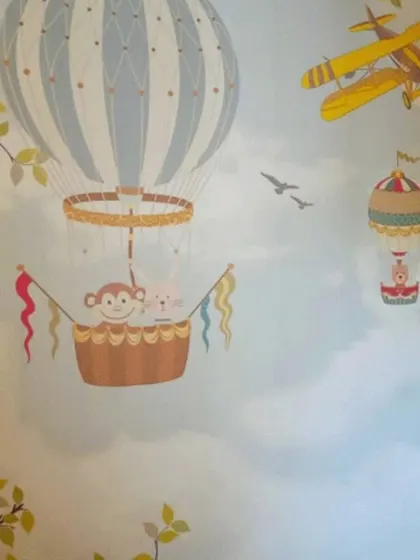 A playful wallpaper featuring monkeys in a hot air balloon, perfect for sparking a child's sense of adventure.