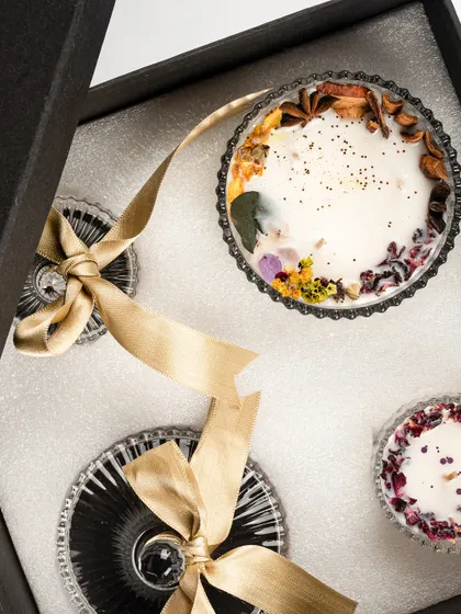 A look inside the 'Eternal Elegance' gift box, showing the intricate details of the crystal jars and the botanical-infused wax. This is a gift designed to impress.