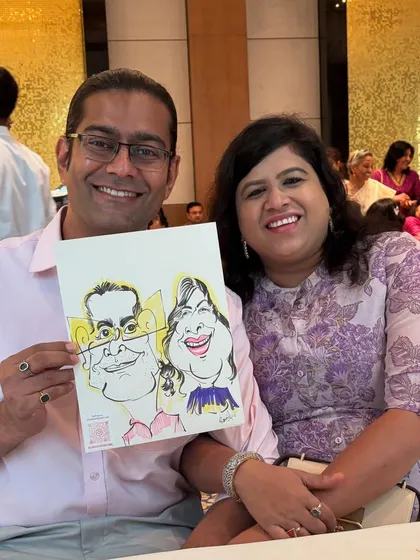 This happy couple loves their caricature, a perfect keepsake from a memorable get-together.