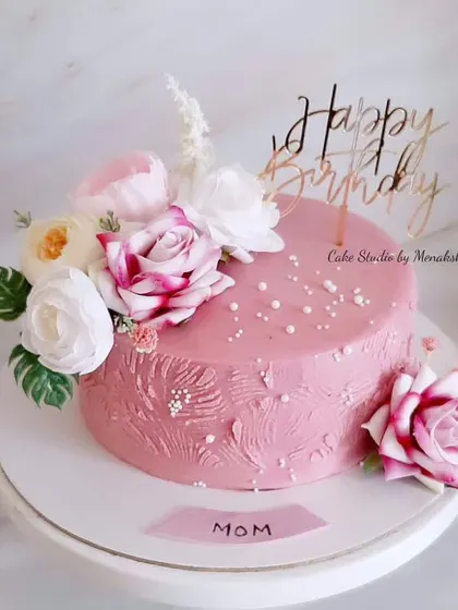 A pretty floral cake for mom. This textured pink buttercream cake is made with zero fondant and decorated with a beautiful arrangement of pink and white roses.
