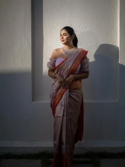 A bride standing in a patch of sunlight against a white wall. This is a duplicate of ID 156, creating a simple yet powerful and artistic portrait.