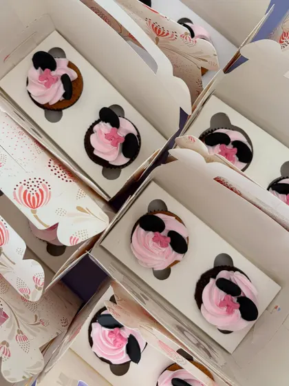 Getting a big order of Minnie Mouse cupcakes ready. It's so satisfying to see them all lined up before they head out to make a party special.