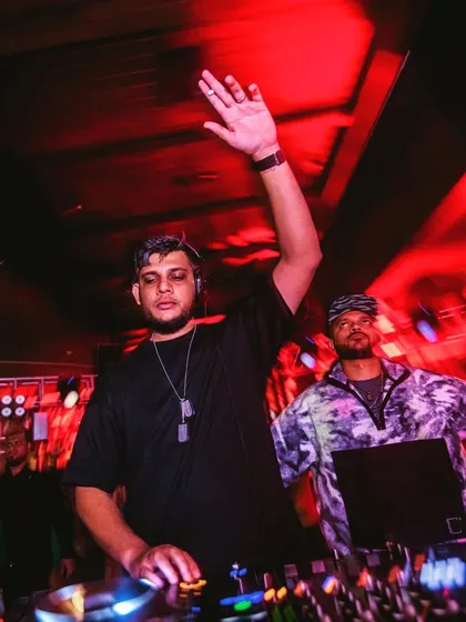 Waving to the crowd during a high-energy moment in the set. Connecting with the audience is what it's all about.
