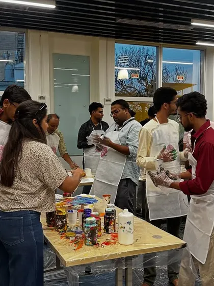 The GoTo Technologies team getting their paint cups ready for the pour. The anticipation is part of the fun.
