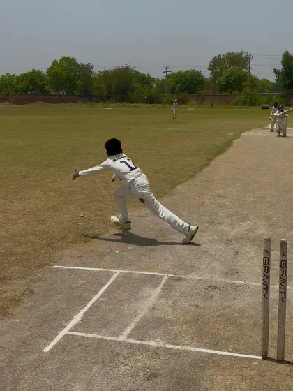 The bowler in his follow-through after delivering a wicket-taking ball.